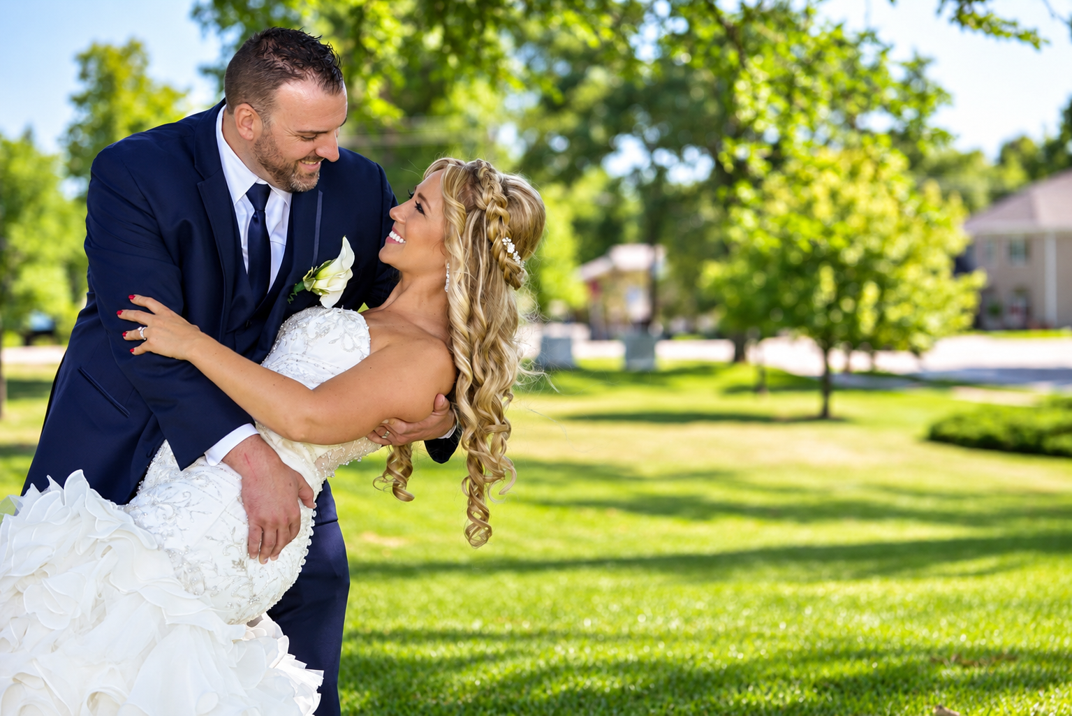 Bride and groom sharing a joyful outdoor portrait